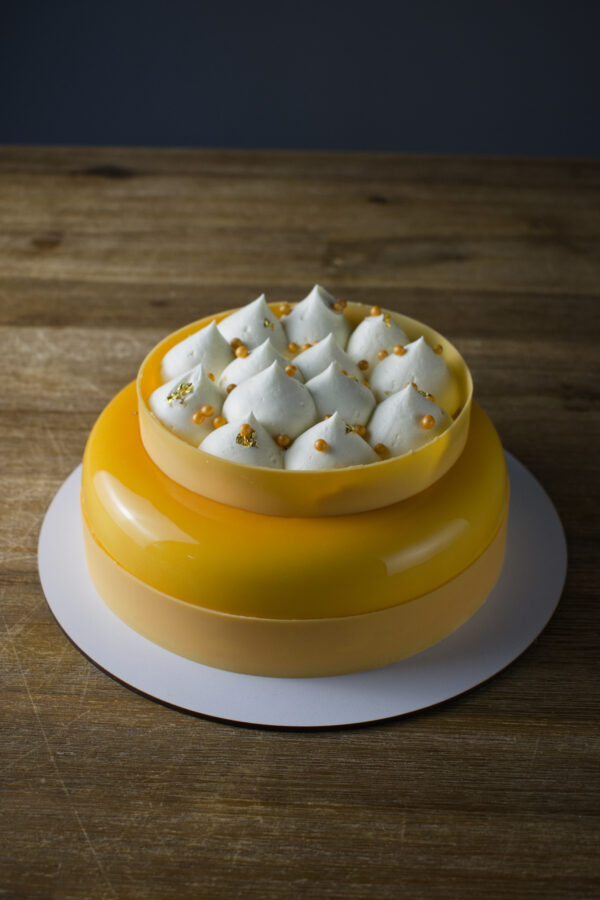 Tropical Coconut, Mango & Passionfruit Entremet front view wood background